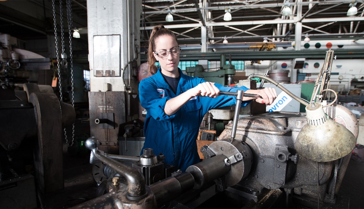 a female employee using a wrench to tighten bolts 